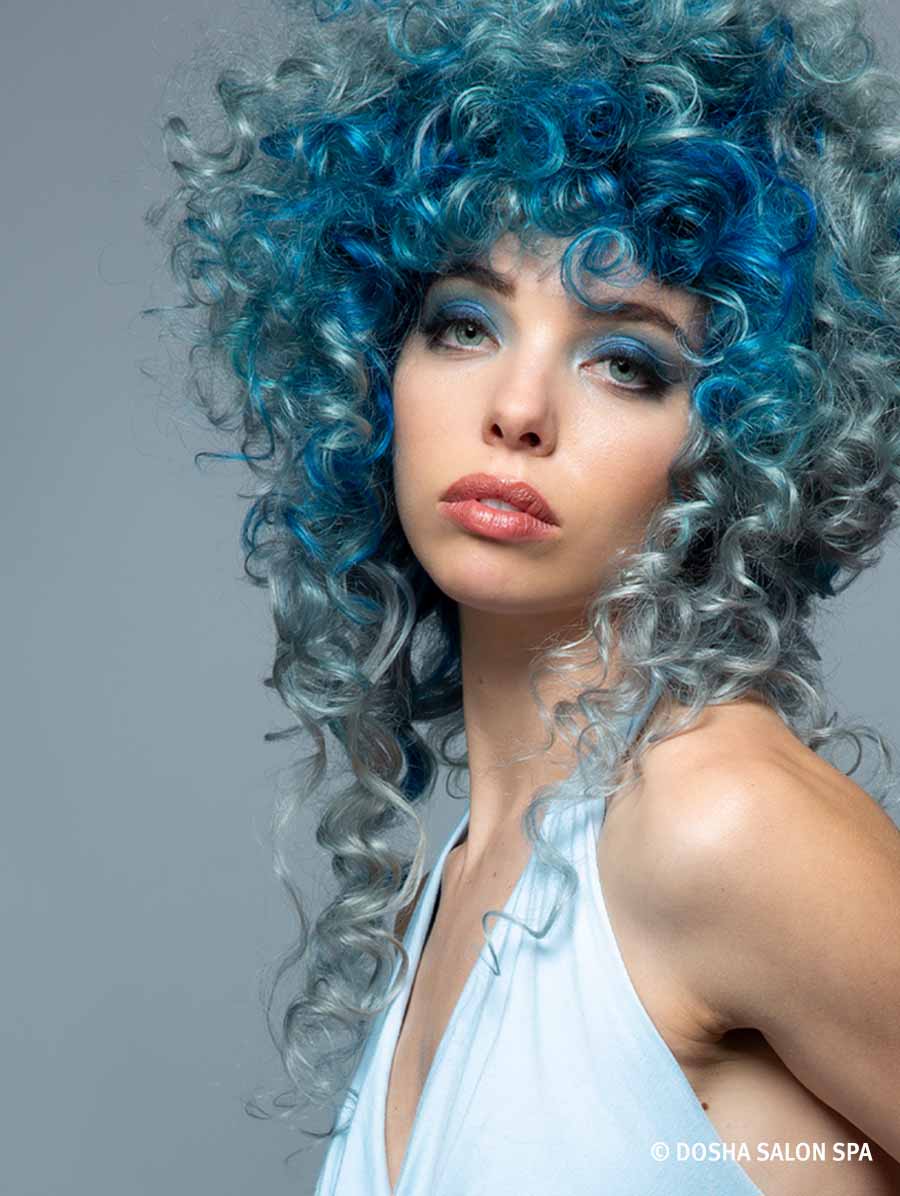 image of a model with hair inspired by crater lake with curly hair in hues of blue and white