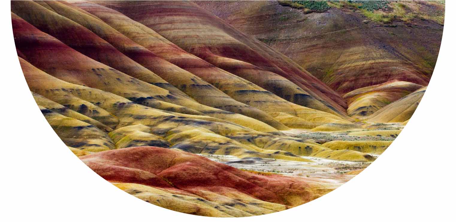 image of the painted hills with striations of Rich rust, ochre, plum, and golden earth tones